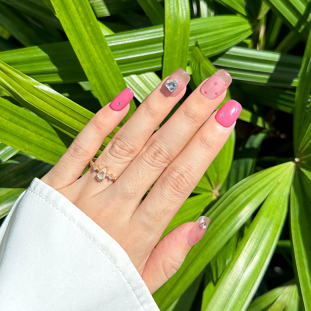 Handcrafted short square-shaped press-on nails in rosy smokey pink with soft pink cat-eye accents, featuring polka dots, stars, and diamond details for a sweet, playful, and charming style.