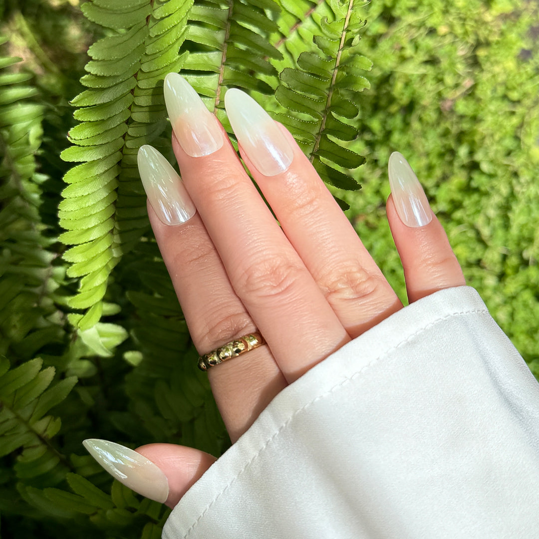 Glossy almond-shaped satin press-on nails in creamy white for a soft, elegant look.