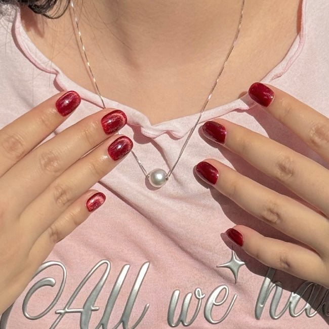 Fincloset Lady Luxe red cat eye press-on nails – short round handmade design with a graceful magnetic shimmer. An elegant and romantic manicure choice for confident, sophisticated women. Glue-free, reusable press on nails for an effortless salon look.