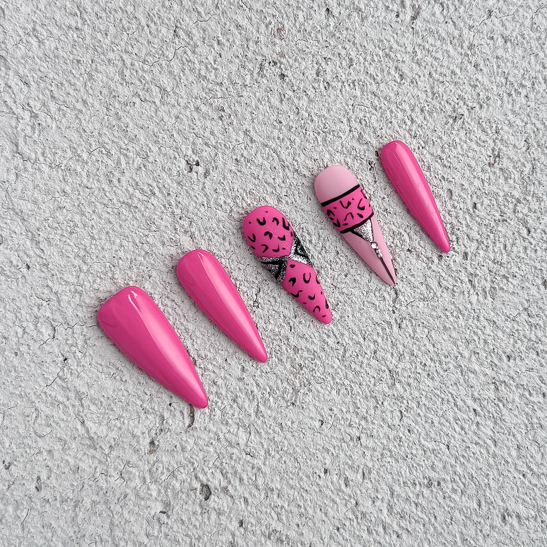 Handmade stiletto-shaped press-on nails in matte and glossy rose pink with bold cheetah print design.