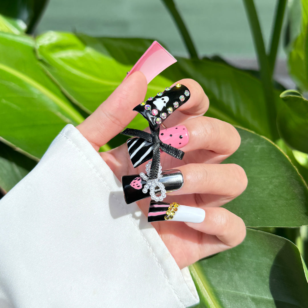 Fierce Sugar handmade duck-bill press-on nails in black and pink with leopard print, ghost art, rhinestones, and bows