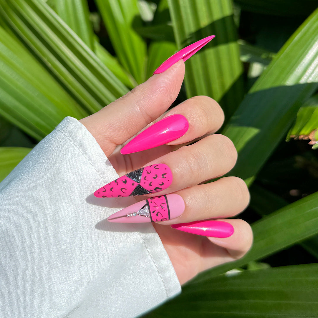 Handmade stiletto-shaped press-on nails in matte and glossy rose pink with bold cheetah print design.