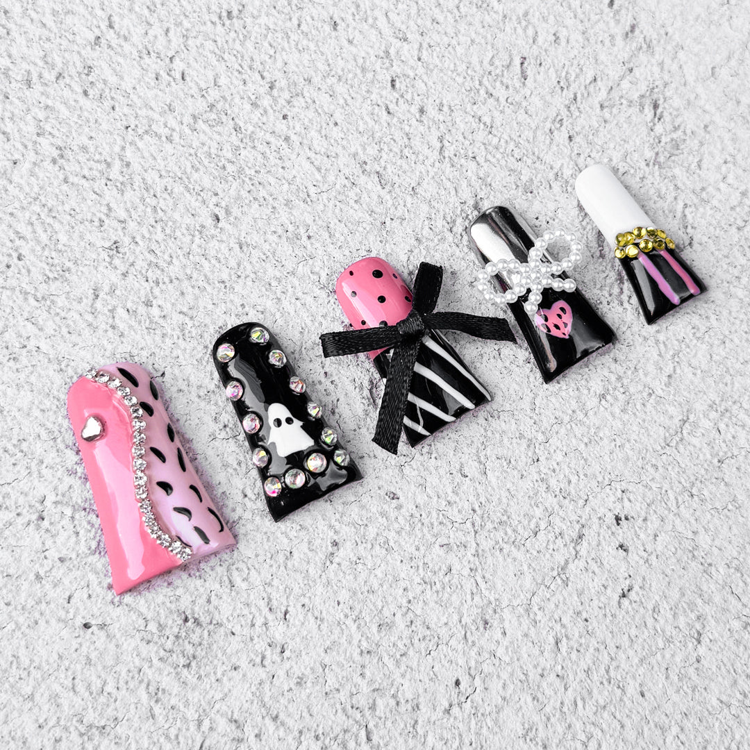 Fierce Sugar handmade duck-bill press-on nails in black and pink with leopard print, ghost art, rhinestones, and bows